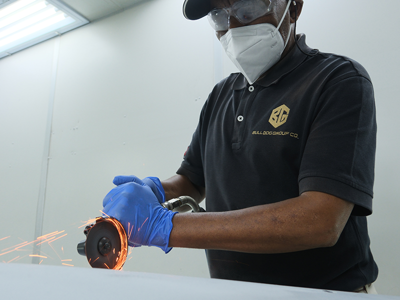 Technician using Hsutech angle grinder cutter head on multi tool body in workshop