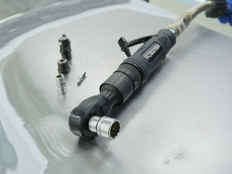 Close up of Hsutech multifunction ratchet wrench head in use tightening bolt
