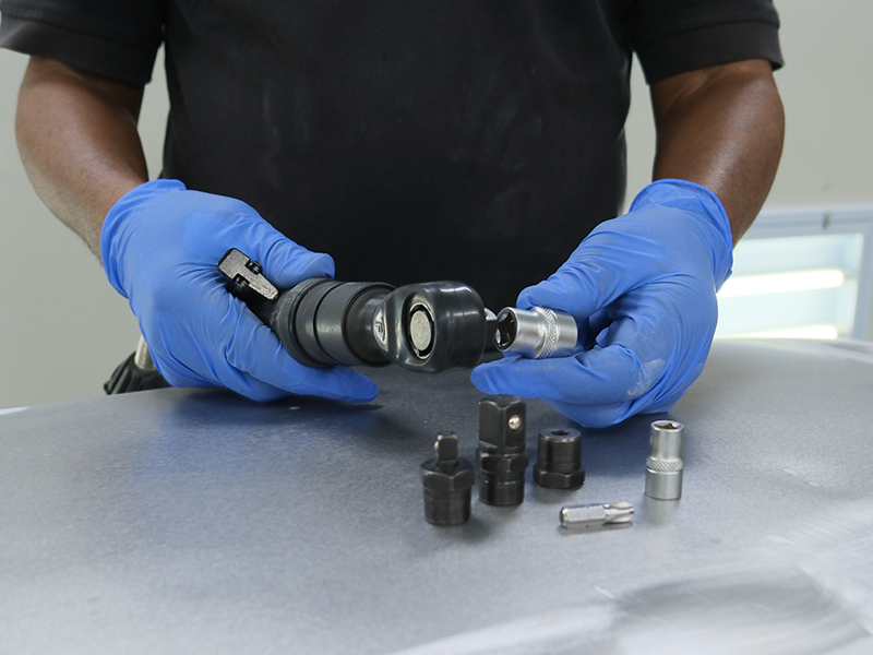 Technician using Hsutech multifunction ratchet wrench head on multi tool body